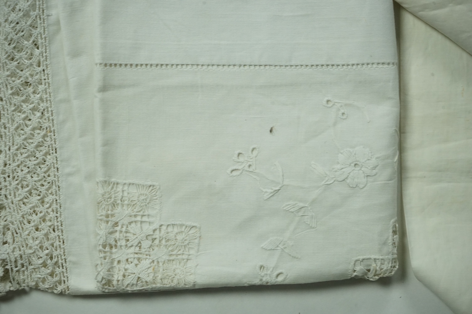 An unusual Victorian white linen hand worked table cloth. Embroidered along one edge, Wrought by L. Grover for her daughter Ethel Frances Burbury 1895. Together with three crochet edged cloths and a circular embroidered